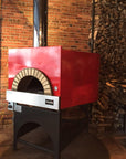 Milano fired oven with a red finish, installed and ready for use.