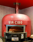 A bright red Napoli fired oven with a custom branded tiling for Via Cibo.